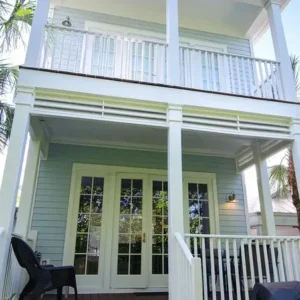 Light blue two-story house with porch